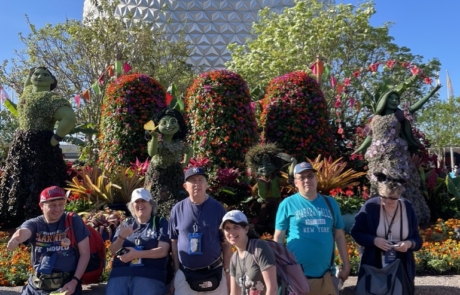 Highlight Vacations travelers with Spaceship Earth and the International Flower Garden Festival at Disney's Epcot. The flowers are done up at famous character from Disney movies.