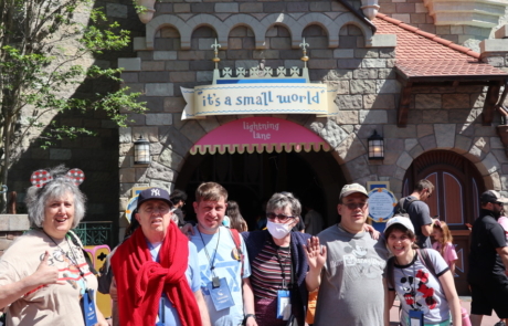 Highlight Vacations travelers at the entry to it's a small world attraction.