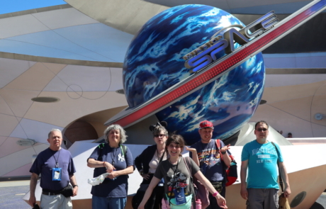 Highlight Vacations travelers posing with mission space attraction sign