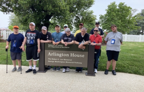 Highlight Vacations travelers standing in front of a sign for the Arlington House in Arlington National Cemetery