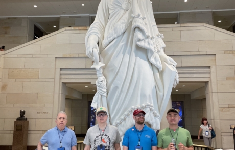 Highlight Vacations travelers standing in front of the statue of Freedom inside of the Capitol building