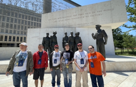 Highlight Vacations travelers standing in front of the Dwight Eisenhower Memorial.