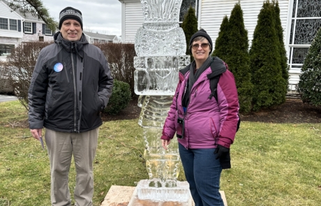 brother and sister in front of ice sculpture