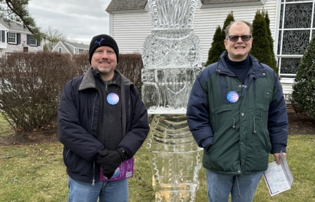 Two brothers standing with an ice sculpture at the First Night Chatham