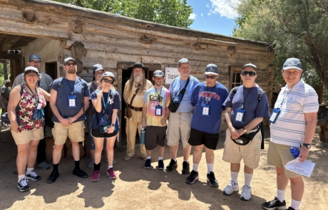 The travelers are standing with the shop keeper of the General store.