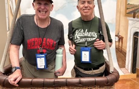 Two travelers are in a hot air balloon basket.