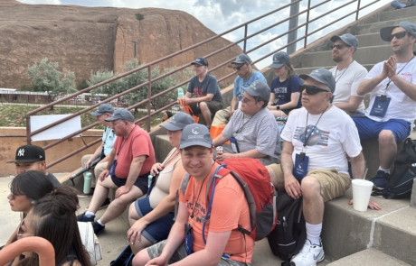 The group is sitting in the stands watching the Rodeo