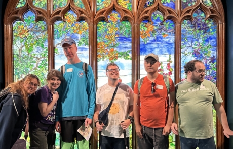 travelers in front of Stain glass window