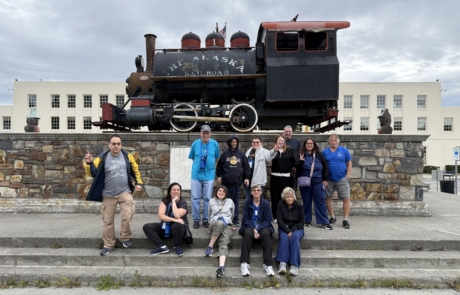 Travelers in front of The Alaska Railroad locomotor in Anchorage