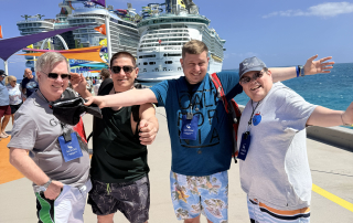Travelers with two of Royal Caribbean's ship in the back