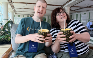travlers enjoying pineapple drinks on deck