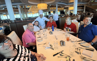 travelers posing with head chef from the Independence of the Seas.
