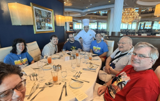travelers posing with head chef from the Independence of the Seas.