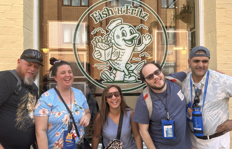 Travelers in front of a Fish 'n' Fritz window